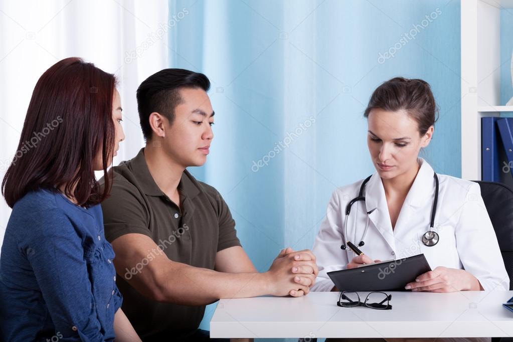 Asian couple during visit at doctor's office
