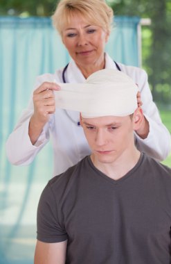 Physician parcels patient's head clipart