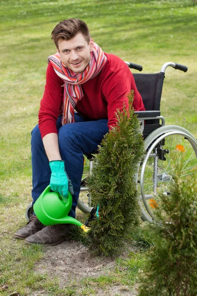 Capable disabled watering flowers — Stock Photo, Image