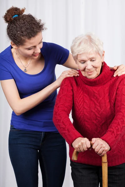 Young woman helping elderly lady Stock Image
