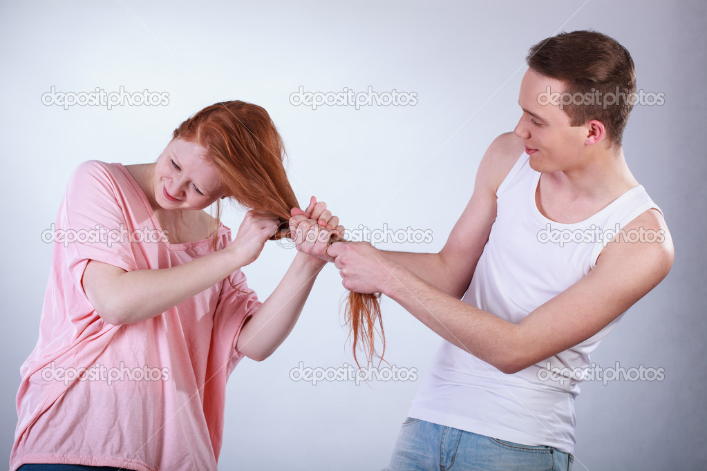 Boy pulling girl hair