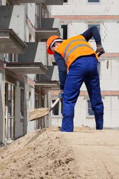 Constructeur travaillant à l'aide de la pelle — Photo