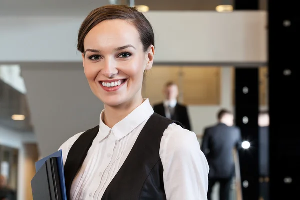 Beautiful woman standing in business centre — Stock Photo, Image