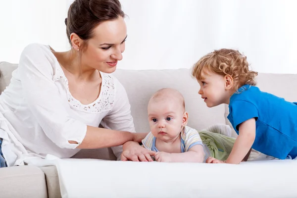 Mother with children on sofa — Stock Photo, Image