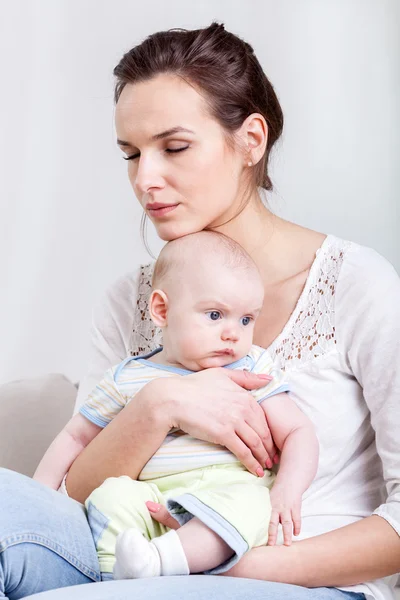 Woman holding baby in hands — Stock Photo, Image