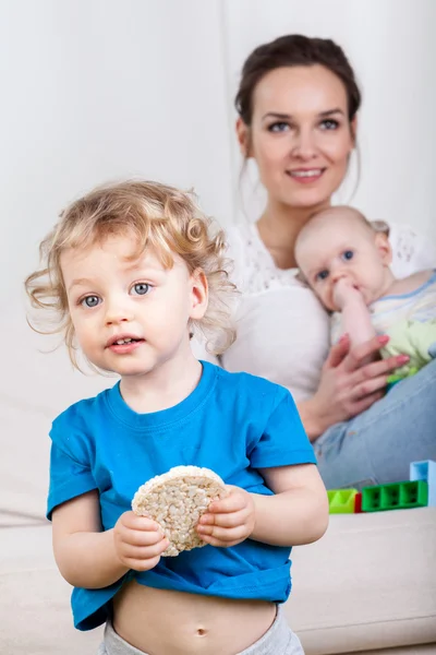 Criança segurando uma bolacha de arroz — Fotografia de Stock