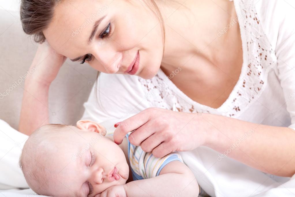 Mother watching over sleeping baby — Stock Photo ©