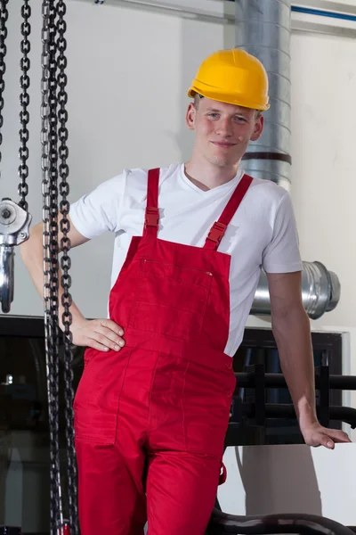 Builder standing near to chain with crane hook — Stock Photo, Image