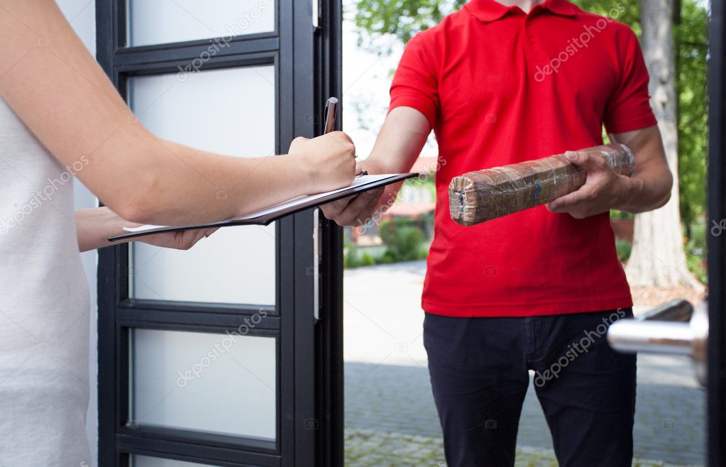 Woman receiving a package from delivery man