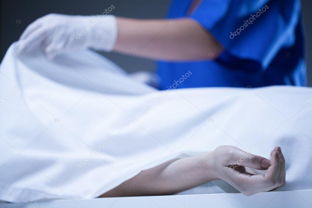 Corpse covered by sheet