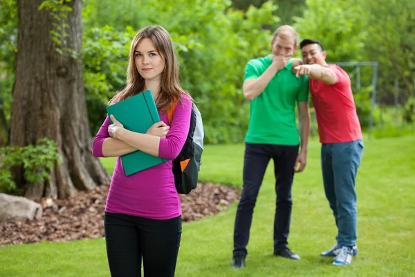 Teenage boys laughing behind girl's back — Stock Photo, Image