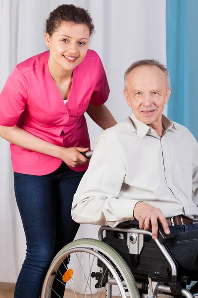 Senior on wheelchair and nurse — Stock Photo, Image