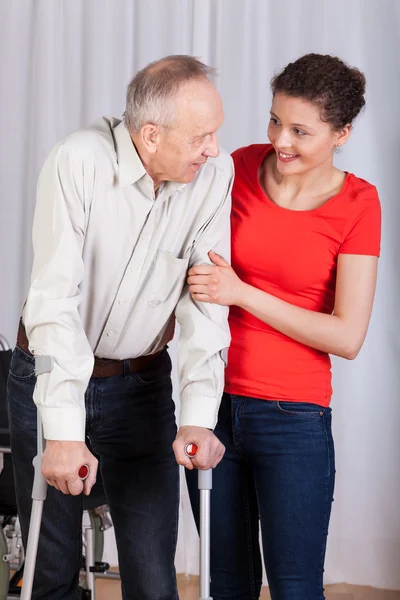 Senior walking with crutches — Stock Photo, Image