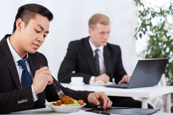 Businessmen eating meal Stock Picture
