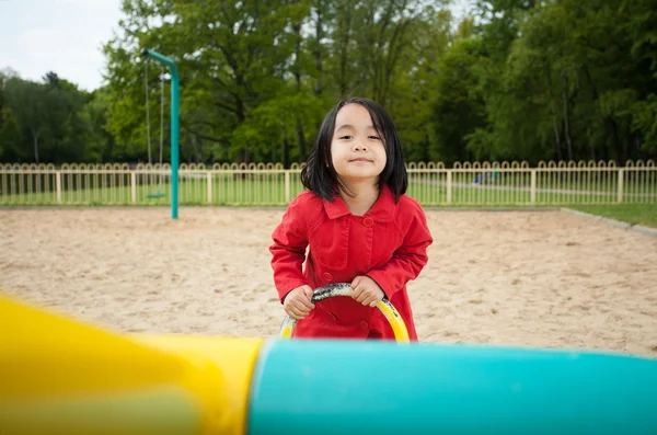 Menina em um playground — Fotografia de Stock