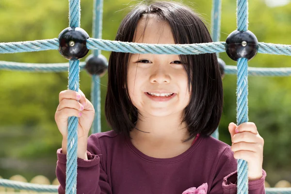 Chica en un parque infantil — Foto de Stock