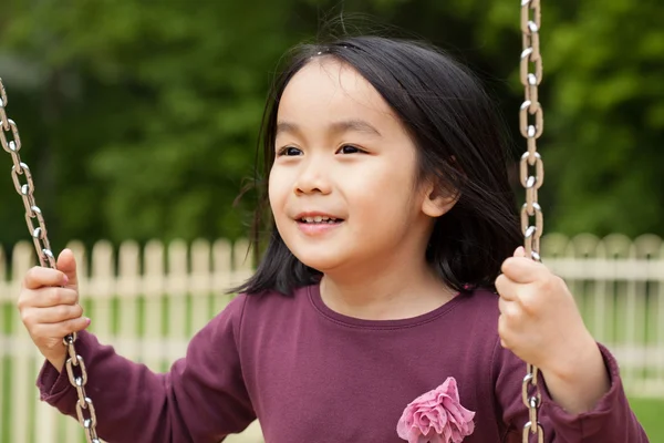 Girl swinging on swing — Stock Photo, Image