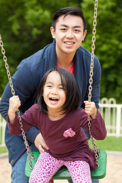 Family on a swing — Stock Photo, Image