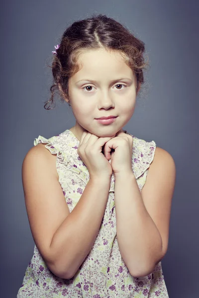 Studio portrait of a beautiful girl with curly hair — Stock Photo, Image