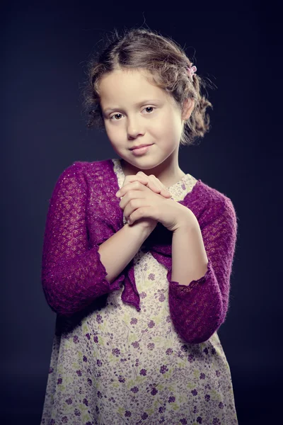 Beautiful girl with curly hair posing in a studio — Stock Photo, Image