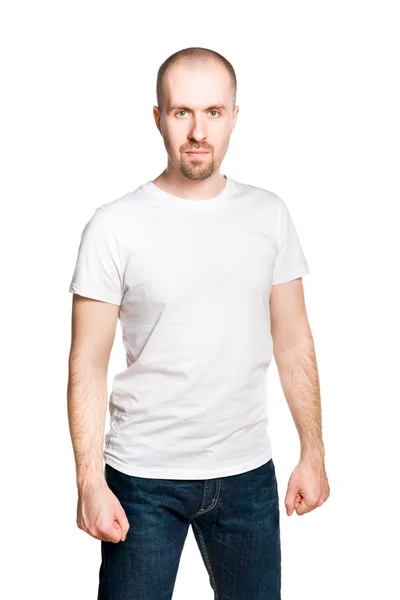 Attractive man with clenched fists in white t-shirt and blue jeans isolated on white — Stock Photo, Image