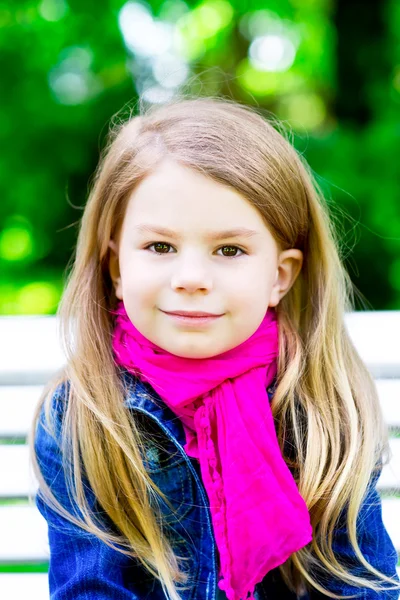 Closeup portrait of a beautiful smiling blond little girl in the — Stock Photo, Image