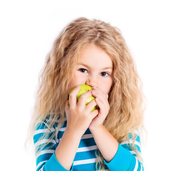 Beautiful blond little girl with long curly hair eating green apple, isolated on white background — Stock Photo, Image