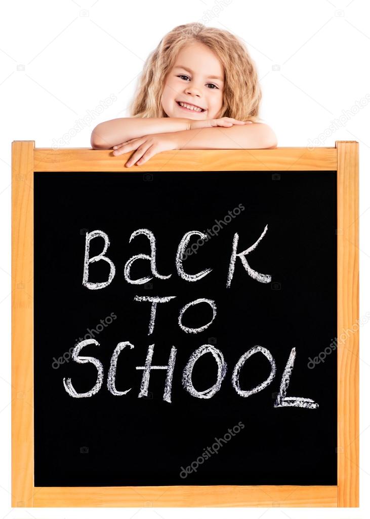 Cute Smiling Blond Little Girl With Curly Hair Leaning On School