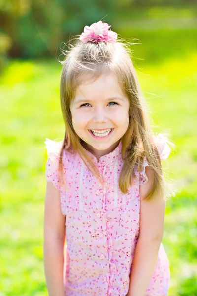 Adorable laughing little girl with long blond hair, outdoor portrait in summer park — Stock Photo, Image