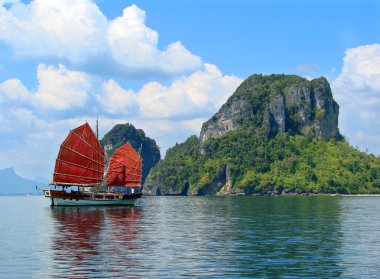 Exotic asian ship with red sails clipart