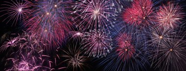 Colorful holiday fireworks panoramic view clipart