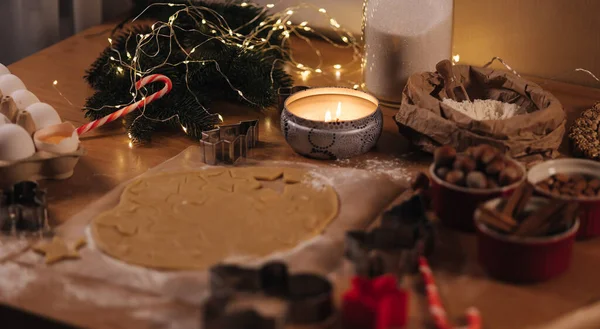 Christmas bakery of gingerbread, cutting cookies of gingerbread dough. Christmas and New Year traditions concept. Candle light — Stock Photo, Image