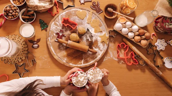 Kış içkisinin en üst görüntüsü, beyaz kazaklı kadın ellerinde lokum olan beyaz kupa. Ev yapımı fırın, geleneksel festival tatlısı pişirmek. Tahta masada zencefilli ekmek hamuru. Yeni yıl kutlaması