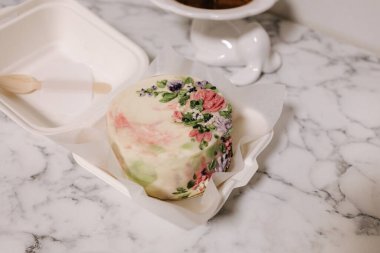 Bayram hediyesi olarak şeker çiçekleriyle süslenmiş küçük bir bento keki. Bir kişi için bir kutuda kekler