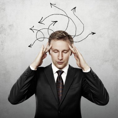 Young businessman thinking with arrows on his head