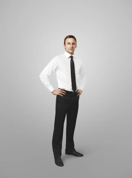 Full length of a business man with hands on hips — Stock Photo, Image