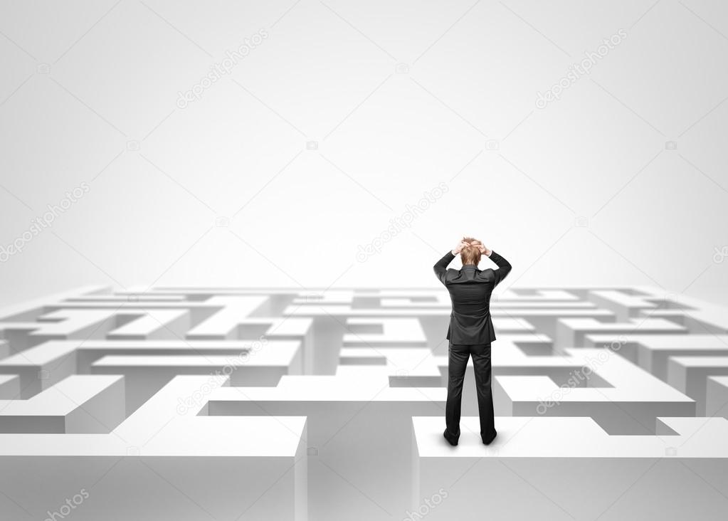 Businessman in front of a huge maze