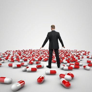 businessman figure standing in front of heap of red pills