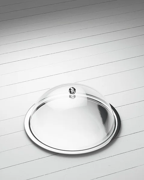 Glossy salver dish with an cover over it on a white wooden background — Stock Photo, Image