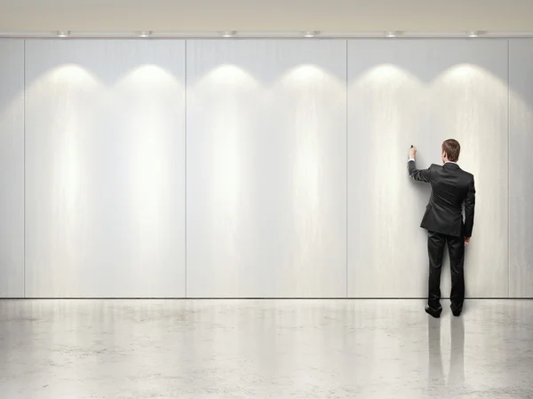 Man drawing on white wall — Stock Photo, Image