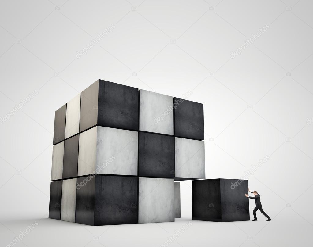 The geometrical image cubes. Businessman moves an enormous weight