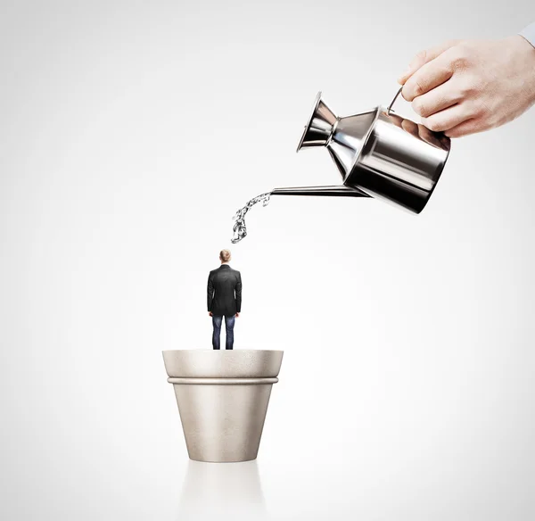 Hand watering businessman — Stock Photo, Image