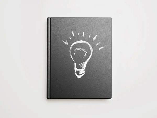 Idea bombilla signo dibujado en la portada del libro — Foto de Stock