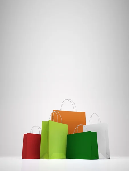 Bolsas de compras de papel colorido en blanco —  Fotos de Stock