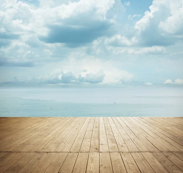 Wooden planks with cloudy sky