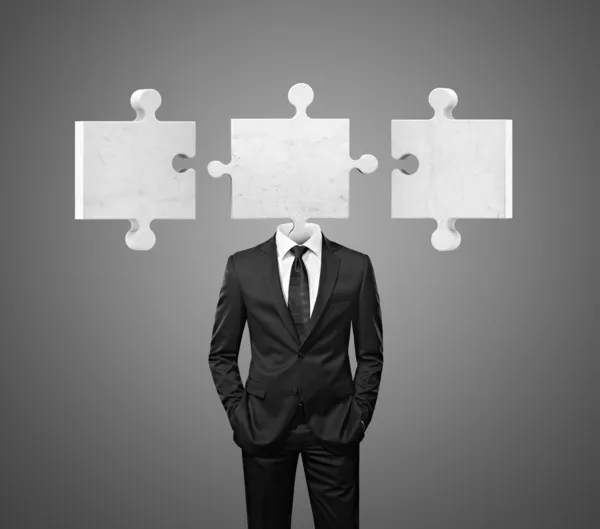 Team of businessman with puzzle pieces instead heads — Stock Photo, Image