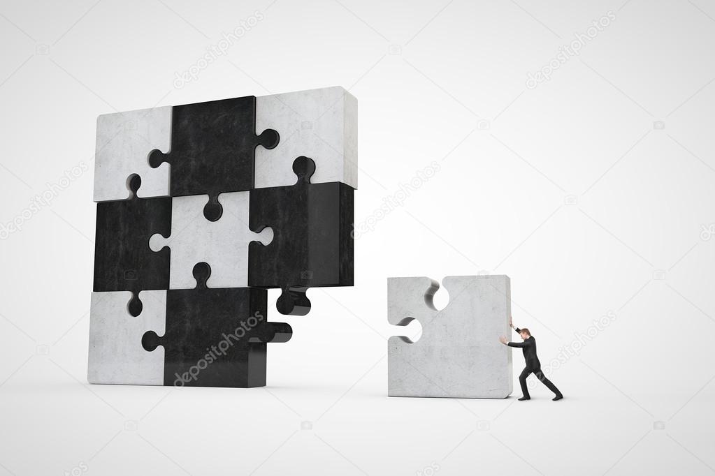 Businessman building puzzle