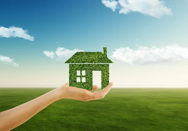 Eco house concept ,hand holding eco house icon in nature — Stock Photo, Image