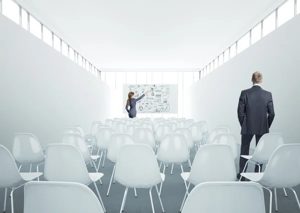 Businesswoman and businessman standing in meeting room — Stock Photo, Image