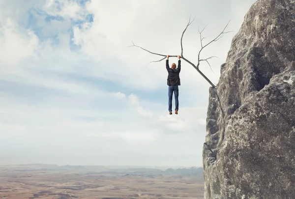 Business man climbs a mountain — Stock Photo, Image